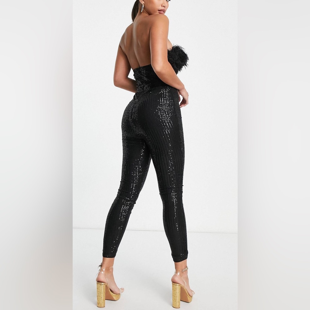 Sequined black jumpsuit with feather trim